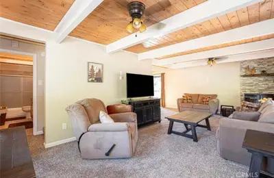 a living room with furniture and a flat screen tv at Bernina Dr. Retreat in Pine Mountain Club
