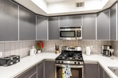 a kitchen with a stove and a microwave at Hollywood Furnished Apartments in Los Angeles
