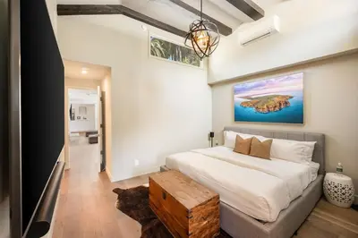 a bedroom with a large bed with a wooden table at Beverly Hills Canyon Villa by Stay Awhile Villas in Los Angeles