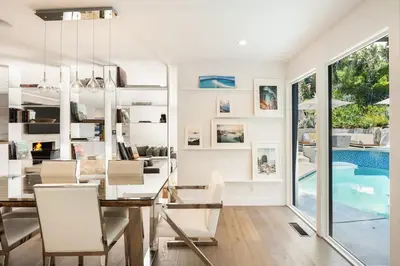 a dining room with a table and chairs and a swimming pool at Beverly Hills Canyon Villa by Stay Awhile Villas in Los Angeles
