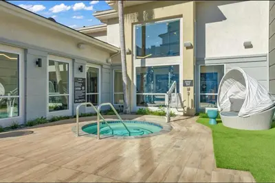 a house with a small pool in the yard at Spacious,2Queen beds, free parking, pool&gym and central location in Marina del Rey