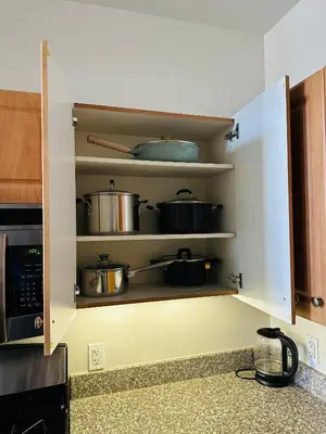 a kitchen cabinet with pots and pans on it at Spacious,2Queen beds, free parking, pool&gym and central location in Marina del Rey