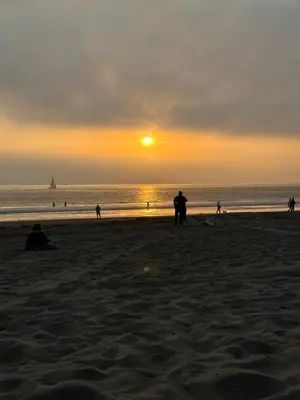 a group of people on the beach at sunset at Spacious,2Queen beds, free parking, pool&gym and central location in Marina del Rey
