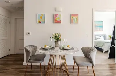 a dining room with a round table and chairs at Hollywood Penthouse with Balcony & Pool View in Los Angeles