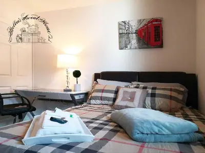 a bedroom with a bed with pillows and a red phone booth at Bella's sweet house 5608 in Eastvale