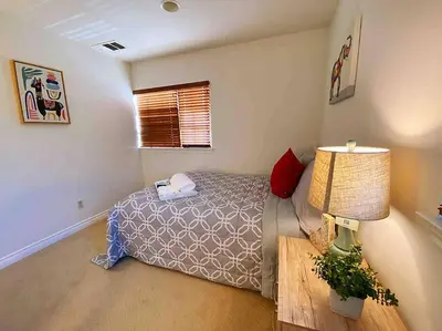 a bedroom with a bed and a table and a lamp at Bella's sweet house 5608 in Eastvale