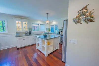 a large kitchen with white cabinets and a blue counter top at Amazing days Spa Pool Villa near Disney & Beaches in Placentia