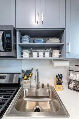 a kitchen with a sink and a microwave at Luxe and Modern South Bay ADU in Carson