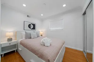 a white bedroom with a bed and a window at # Marbella Lane - Serene & Spacious 3BR Haven in West Covina