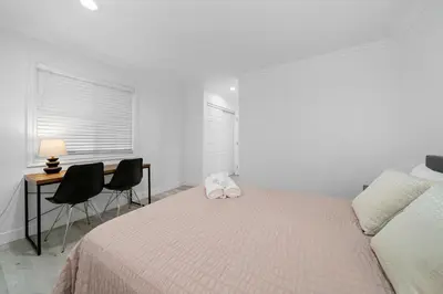 a bedroom with a bed and a desk and chairs at # Marbella Lane - Serene & Spacious 3BR Haven in West Covina