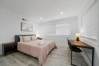 a bedroom with a bed and a desk and window at # Marbella Lane - Serene & Spacious 3BR Haven in West Covina