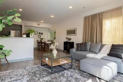 a living room with a couch and a table at Charming 2bd Condo on SunsetStrip in Los Angeles