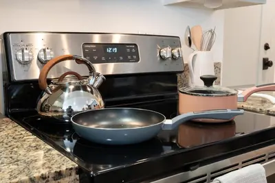 a bowl on a stove with a tea kettle on it at Charming 2bd Condo on SunsetStrip in Los Angeles