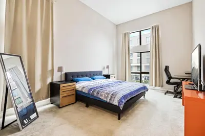 a bedroom with a bed and a mirror and a desk at Ultimate LA Vacation 2BR w Pool Above Shops in Monterey Park