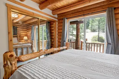 a bedroom with a bed in a log cabin at Lakeview Lodge - Across the street from the lake and Boulder Bay Park! in Big Bear Lake
