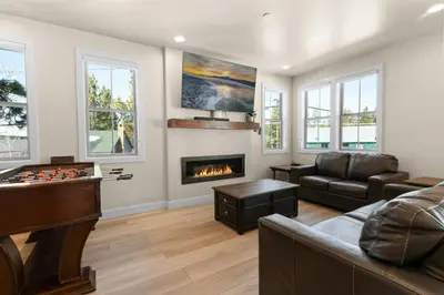 a living room with a couch and a fireplace at Pine Meadow - Game Room with pool table, foosball & shuffleboard! in Big Bear Lake