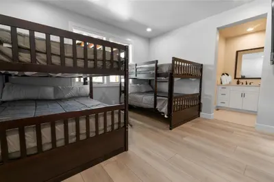 two bunk beds in a room with a bathroom at Pine Meadow - Game Room with pool table, foosball & shuffleboard! in Big Bear Lake