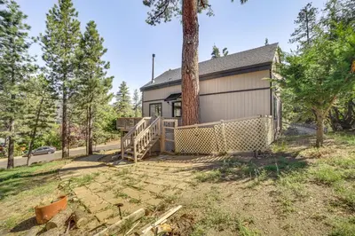 a house with a garage and a tree at Pine Mountain Club Cabin with AandC and EV Charger in Pine Mountain Club