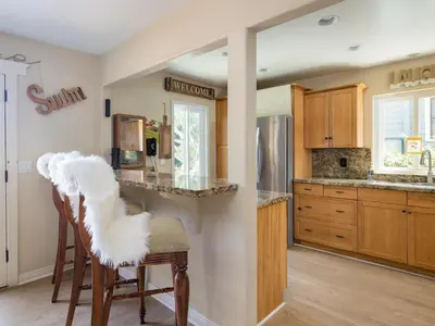 a kitchen with wooden cabinets and a counter top at El Segundo Beach 5B4b Home, POOL Hot Tub, BEACHES, Local Town! in El Segundo