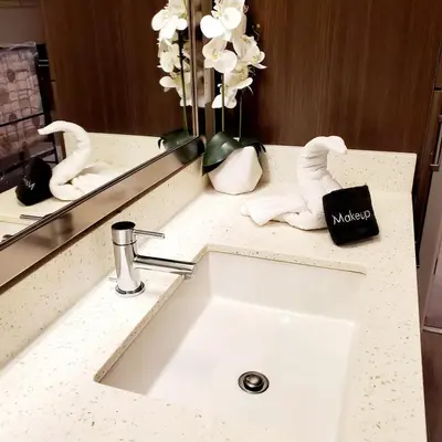 a bathroom counter with a sink and a mirror at Spacious 22, Wi-fi, Pool, Hot Tub, 24hr Gym in Los Angeles