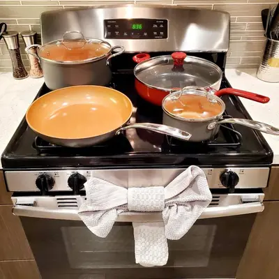 three pots and pans on a stove in a kitchen at Spacious 22, Wi-fi, Pool, Hot Tub, 24hr Gym in Los Angeles
