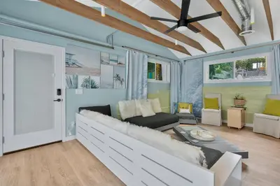 a living room with a couch and a table at NEW BEACH Pool Home, New Industrial OCEAN Vibe, Hot Tub, Pool, Views in El Segundo