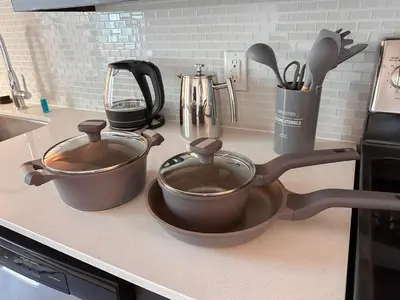 two pots and pans sitting on a kitchen counter at City View Suite - DTLA by Monthier in Los Angeles