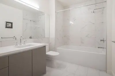a white bathroom with a tub and a toilet and a sink at City View Suite - DTLA by Monthier in Los Angeles