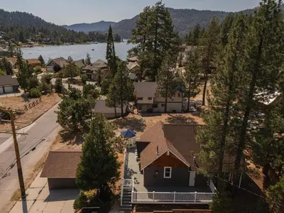 an aerial view of a house with trees and a lake at Blissful Bay Cabin in Big Bear Lake