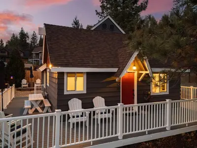 a small house with a white fence and chairs at Blissful Bay Cabin in Big Bear Lake