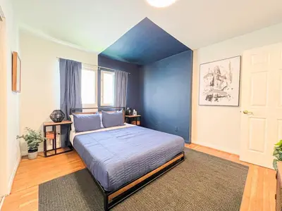 a bedroom with a large bed with blue walls at Diamond in Los Angeles- AM3 in Los Angeles
