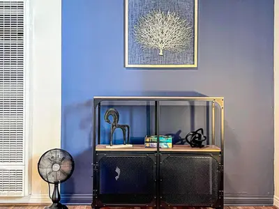 a blue room with a fan and a glass cabinet at Diamond in Los Angeles- AM3 in Los Angeles