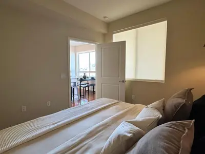 a bedroom with a large bed and a dining room at Stylish 1 Bedroom Apartment in LA with Free Parking - 10 Minutes away from Ceders Sinai in Los Angeles