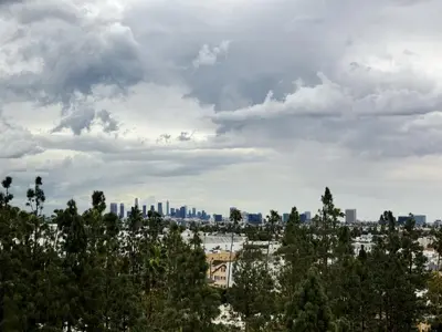 a cityscape of a city with trees in the foreground at Cosmopolitan Hollywood Home DTLA view Parking - 10mins to Universal Studios in Los Angeles