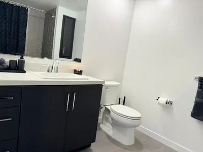 a bathroom with a white toilet and a sink at Cosmopolitan Hollywood Home DTLA view Parking - 10mins to Universal Studios in Los Angeles
