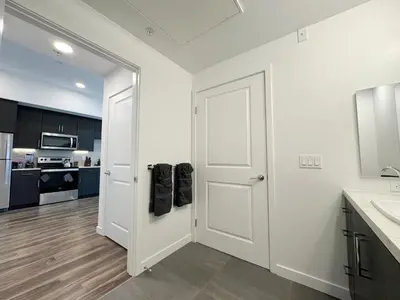 a kitchen with a white door and a sink at Modern Hollywood Home Sunset View & Free Parking - 10mins to Universal Studios in Los Angeles