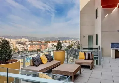 a balcony with couches and a view of a city at Cozy Home in LA - Free Parking 10 Min to Cedars in Los Angeles