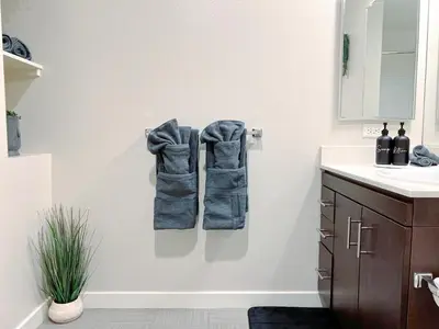 a bathroom with two towels hanging on a wall at Cozy Home in LA - Free Parking 10 Min to Cedars in Los Angeles