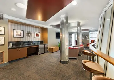 a lobby with a waiting area with chairs and a bar at Cozy Home in LA - Free Parking 10 Min to Cedars in Los Angeles