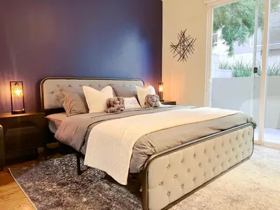 a bedroom with a large bed with two teddy bears on it at Cozy Home in LA - Free Parking 10 Min to Cedars in Los Angeles