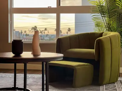 a living room with a chair and a table at Luxurious Hollywood Home City View - Free Parking 10mins to Universal Studios in Los Angeles