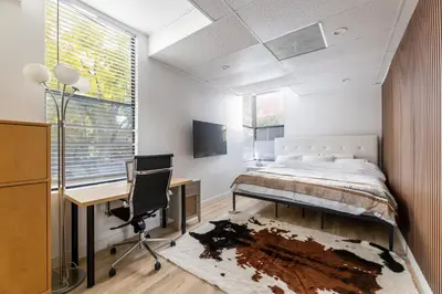 a bedroom with a bed and a desk and a chair at Quiet King bed Westward Room in heart of Pasadena in Pasadena
