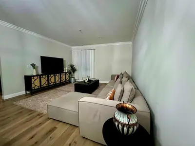 a living room with a couch and a flat screen tv at Shared House Hollywood Hideaway Heart of Fame in Los Angeles