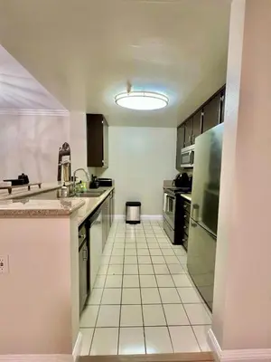 a large kitchen with a white tiled floor at Shared House Hollywood Hideaway Heart of Fame in Los Angeles