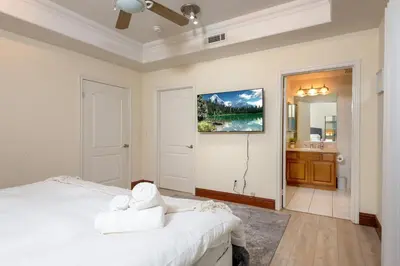 a white bedroom with a bed and a bathroom at Luxurious Apt Your Private Gem in LA in Los Angeles