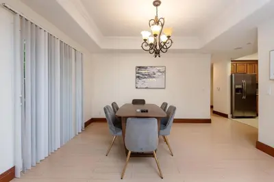 a dining room with a table and chairs and a chandelier at Luxurious Apt Your Private Gem in LA in Los Angeles