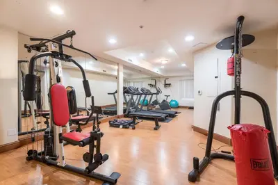 a gym with several treadmills and exercise bikes at Luxurious Apt Your Private Gem in LA in Los Angeles