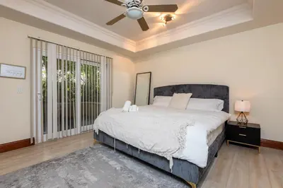 a bedroom with a bed and a ceiling fan at Luxurious Apt Your Private Gem in LA in Los Angeles