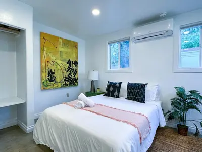a bedroom with a bed and a painting on the wall at Monthier Picfair Village CA1G6H23 in Los Angeles