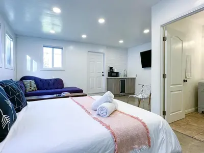 a bedroom with a large bed and a blue couch at Monthier Picfair Village CA1G6H23 in Los Angeles